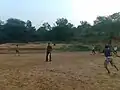 Playing cricket on the bank of the Vatrak River