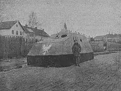A man standing in front of an armored car
