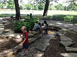 Children playing in the stream at Franklin Park in Prairie Village, Kansas