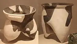two pots, one with separated gourd-shaped feet and a high neck, and the other with a much smoother outline