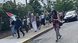 Pro-Palestinian protesters march through a street in downtown Bloomington on May 7, 2024.