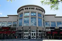 An entrance to the shopping mall, in this case half a decagon with large windows on each face above entryway doors, providing a large and brightly-lit foyer.