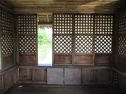 Bahay kubo interior featuring sliding capiz shell windows