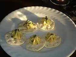 A platter of wafer crackers with poichichade piped onto them