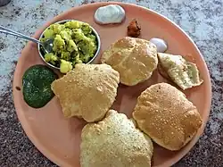 Puri Bhajji in Mumbai restaurant, served with potato bhaaji and coriander leaf chutney
