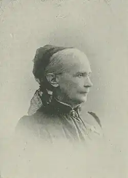 B&W portrait photo of an elderly woman with her hair in an up-do