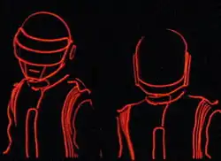 Two robotic figures outlined in red can be seen against a black background.