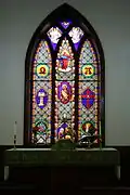 The altar and central stained glass window