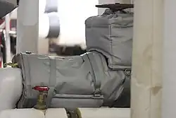 A removable insulation blanket installed on a steam system component.