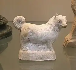 A terracotta figure of a small, fluffy dog, made in Italy in the 1st century BC – 1st AD