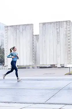 Designed by architect Philip Johnson and erected in 1970, the concrete memorial to President Kennedy dominates a square in downtown Dallas near Dealey Plaza, where the president was assassinated. Johnson's design is a cenotaph, or open tomb, that symbolizes the freedom of Kennedy's spirit. The memorial is a square, roofless room, 30 feet high and 50 x 50 feet wide with two narrow openings facing north and south.