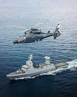 An AS565 Panther Atalef of 193 Squadron is flying above its Sa'ar 6-class corvette in 2024