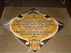 Plaque marking the spot where Jacques Cartier knelt to receive the blessing of the bishop of Saint Malo before his voyage to Canada in 1535. The plaque records that Honoré Mercier, the Premier of Quebec, visited the cathedral in 1891.