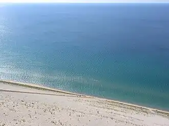 View from Lake Michigan Overlook, with people climbing up the dunes