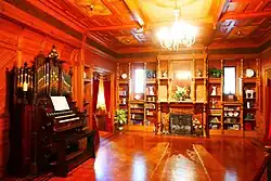 Organ, fireplace, and windows with Shakespeare quotes