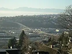 A bridge spanning between residential neighborhoods through an industrial district