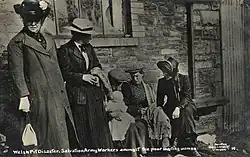 A female Salvation Army officer comforts a family