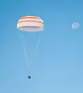 The Soyuz TMA-21 capsule descends toward landing.