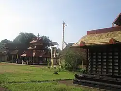 Side of a closed pavilion, with the temple in the background