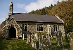 A single-storey church built in rubble stone with a bellcote and a porch at the Western end
