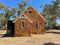 Stone school building in country setting