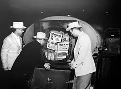 Photo of Texas Liquor Control Board agents viewing a stash of illegal alcohol.