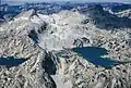 Aerial view of Glacier Peak in upper left, Eagle Cap shaded in upper right, Prospect Lake lower left, Glacier Lake to right.