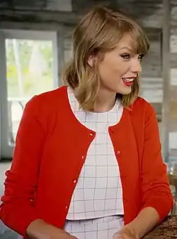 Side profile of Swift, dressed in a red jacket