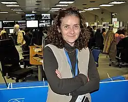 Rodrigo in the foreground, with other people sitting at desks in the background.
