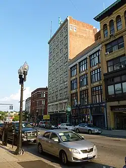 A photo from the ground of the orange skyscraper.