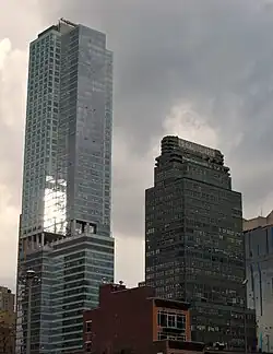 The building as seen from the southeast in 2011. The Orion apartment building, a glass tower, is visible to the left, while 330 West 42nd Street is visible to the right.