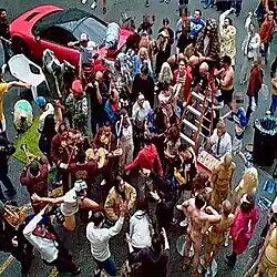 An overhead photo of a crowd of people gathered in the street.