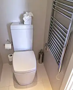 Close coupled cistern type flushing toilet.