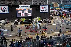 Six robots sit on the field before a match.