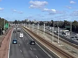 A section of the Kwinana Freeway where the median strip widens, viewed from a bridge