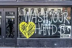 Wash your hands window in Dame Street Boarded up