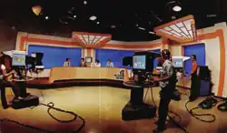 An orange, cream, and blue set in 1970s decor