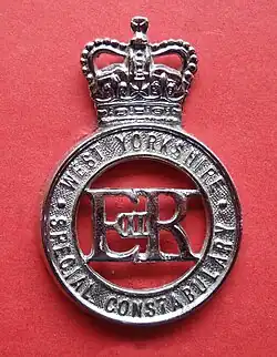 The cypher of Queen Elizabeth II on a police cap or helmet badge