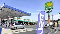 A curved nobori used to advertise a Cosmo petrol station