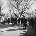 President Lyndon B. Johnson, Lady Bird Johnson, and the Johnson family walking from the White House as part of the funeral procession accompanying President Kennedy's casket to Cathedral of St. Matthew the Apostle on November 25, 1963.