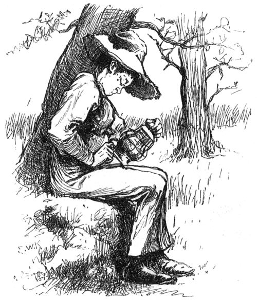 boy sitting under a tree rubbing an oil lamp