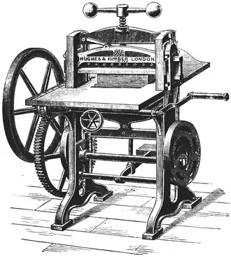 Cross-hatched drawing of a table-like bench, with many wheels and handles.