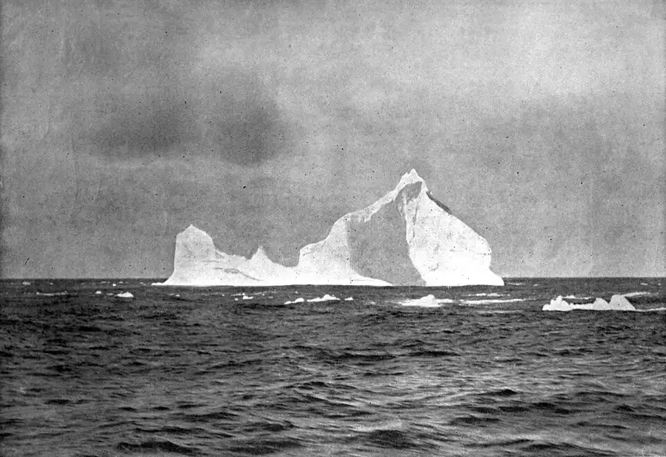 An iceberg surrounded by the sea"