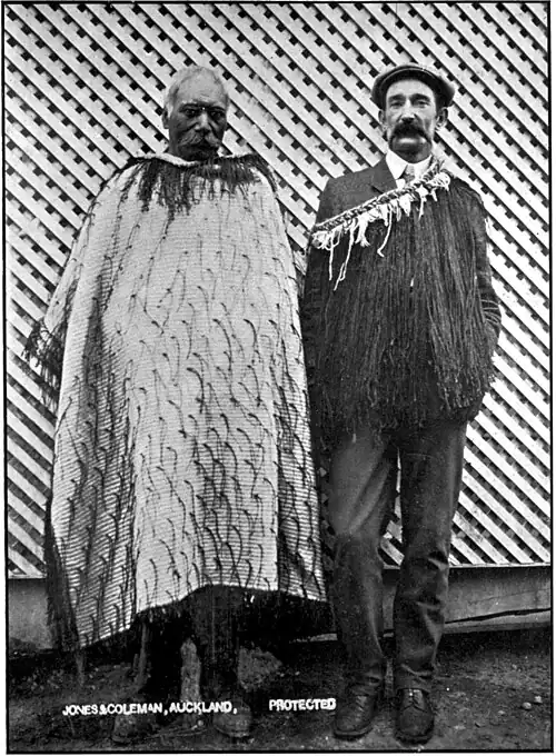 Two Māori men, one in traditional dress