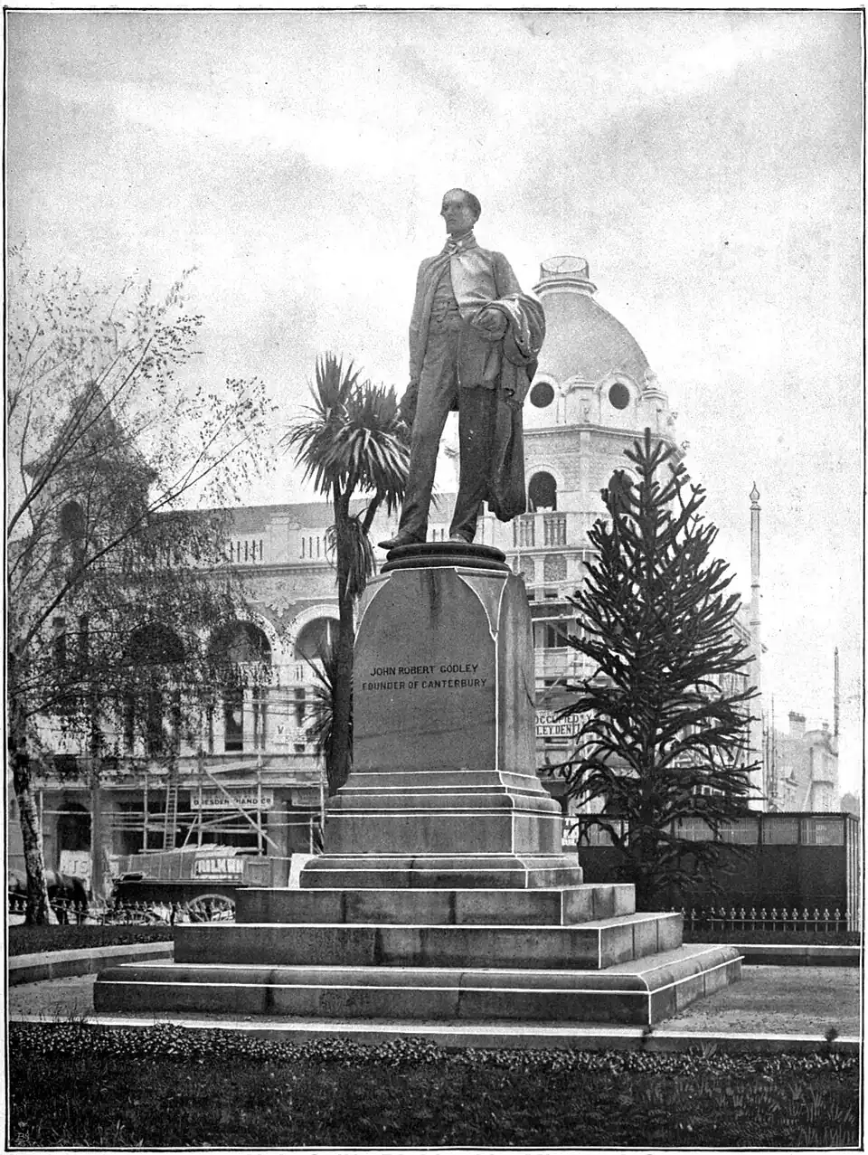 A statue of John Robert Cooley, with his name on the stand.