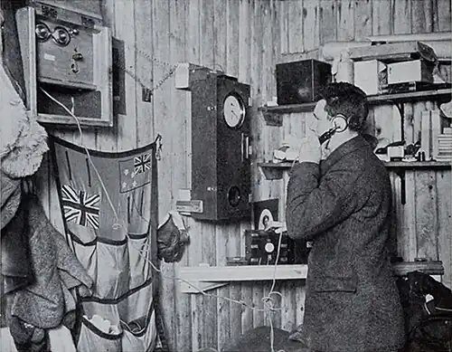 Photo of a man on an old-fashioned telephone in the corner of a hut