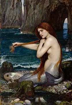 A mermaid sitting on a rock, combing her hair