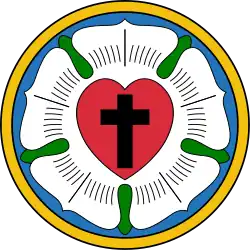 A five-petalled white rose with a stylised red heart in its centre and black cruciform cross in the centre of the heart.