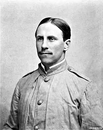 Black and white photograph of a man in a coat.