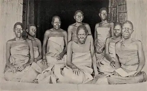 A group of boys and men seated